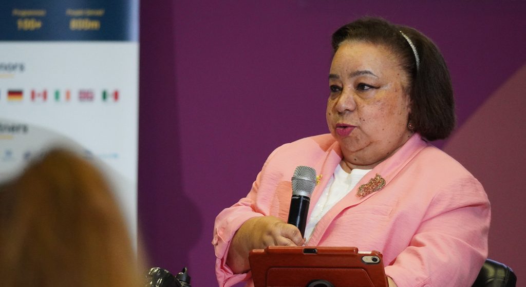 Ms. Hagrass speaking into a microphone