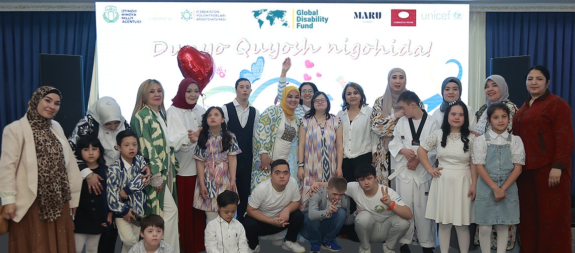 Children and adults with and without disabilities pose for a group photo